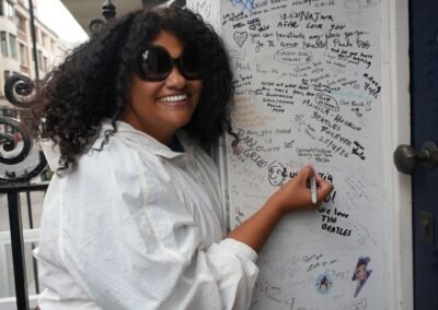 Beatles fan signing the Abbey Road wall during a London ebike Beatles tour