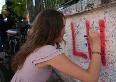 Guest signing the Abbey Road wall during a Beatles London e-bike tour