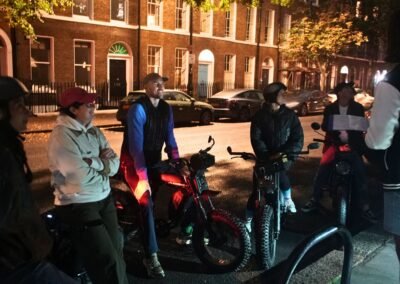 Guests enjoying the Dickens Christmas London e-bike tour with their guide on a festive evening ride.