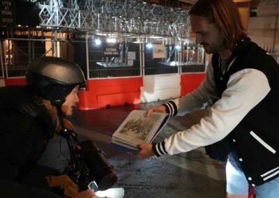 FOF Bike Tours guide showing historical material to a guest during the Dickens Christmas London e-bike tour.